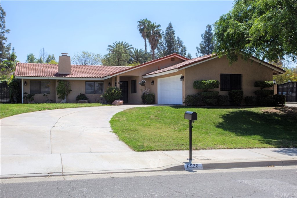 6526 Marlo Way Riverside, CA 92506 - Photo 1 of 1 a front view of a house with a garden and plants