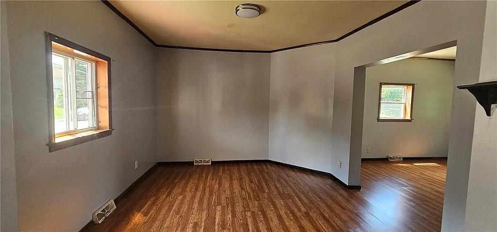 115 North Ray Street New Castle, PA 16101 - Photo 4 of 9 an empty room with wooden floor and windows