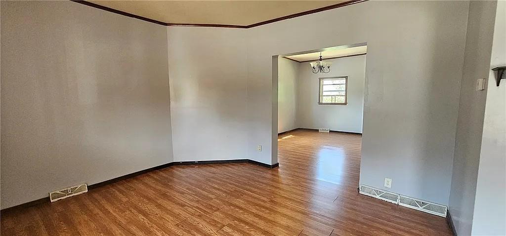 115 North Ray Street New Castle, PA 16101 - Photo 5 of 9 a view of an empty room with wooden floor and a window