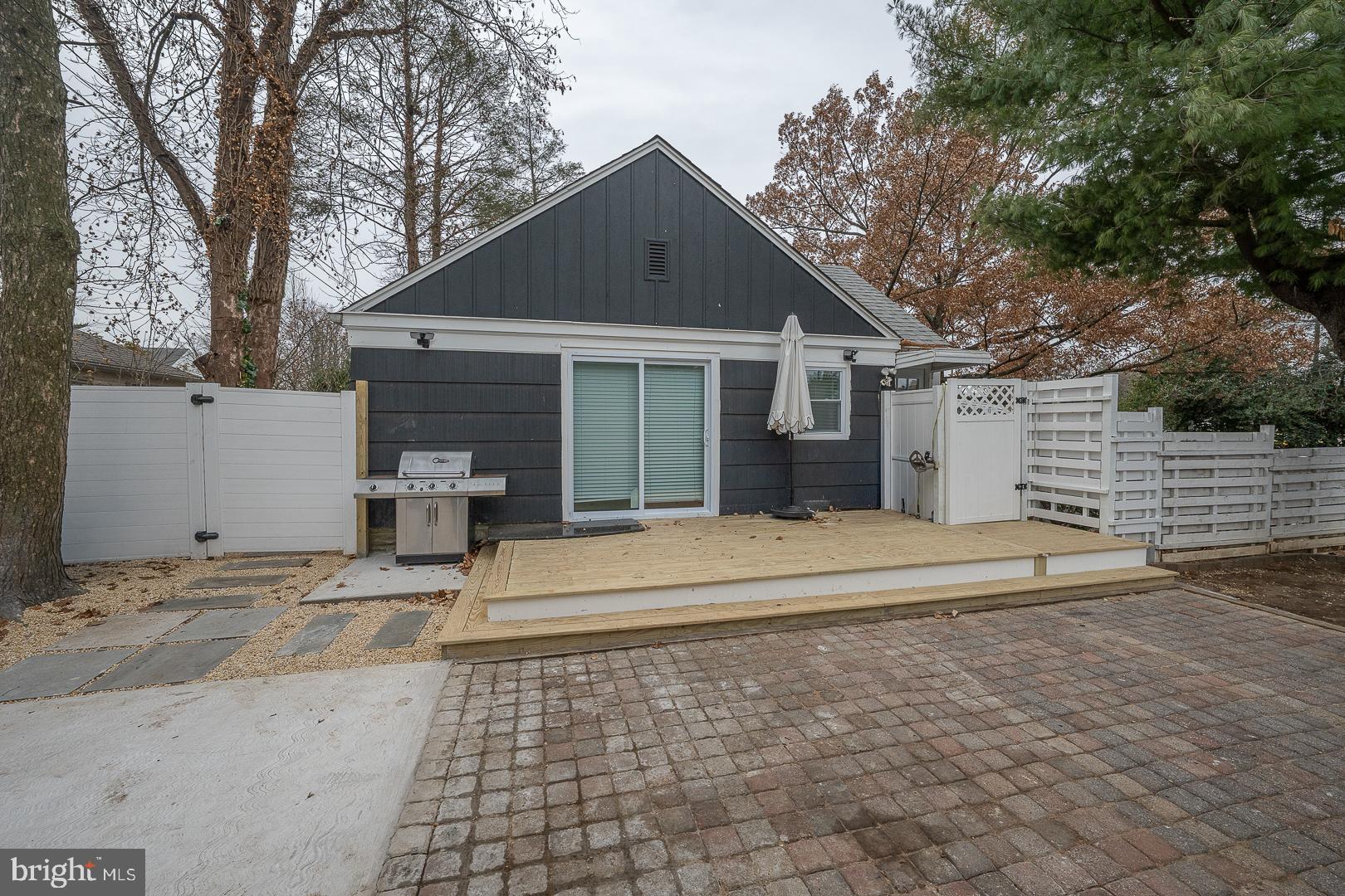 1022 Clover Hill Road Wynnewood, PA 19096 - Photo 39 of 40 a front view of a house with a yard and garage