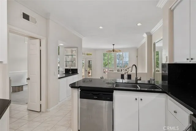 a kitchen with stainless steel appliances kitchen island granite countertop a sink and cabinets