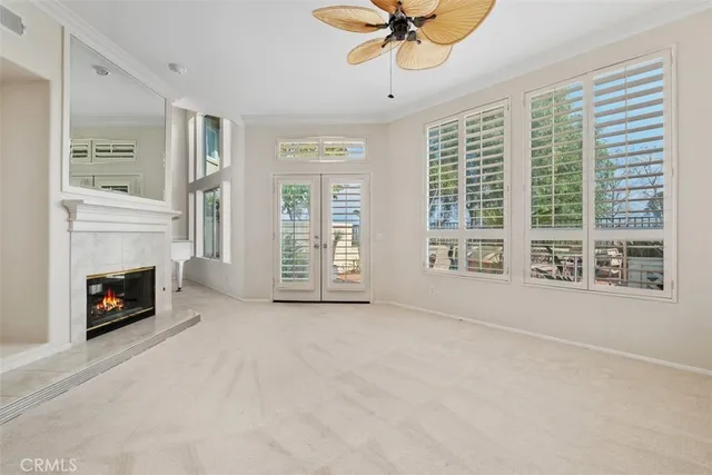 a view of an empty room with a fireplace and a window
