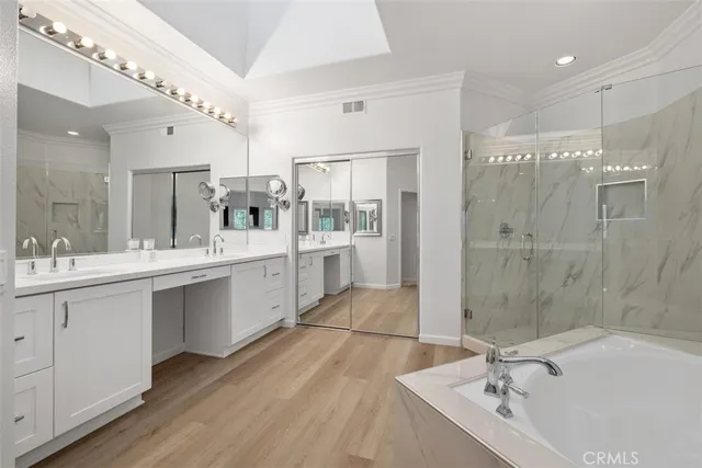 a large bathroom with a double vanity sink mirror and shower