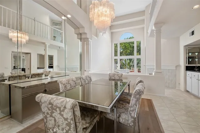 a dining room with furniture and a large window