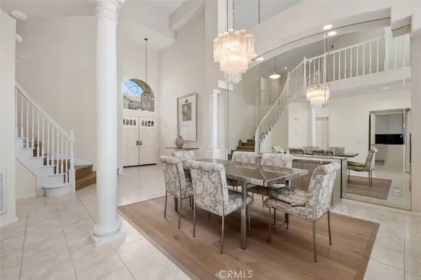 a view of a dining room with furniture and a chandelier