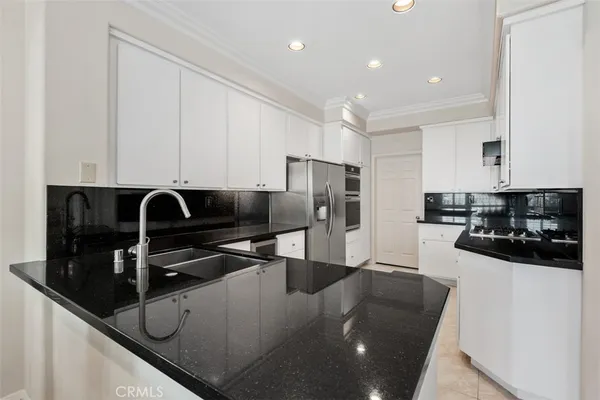 a kitchen with stainless steel appliances granite countertop a sink and cabinets