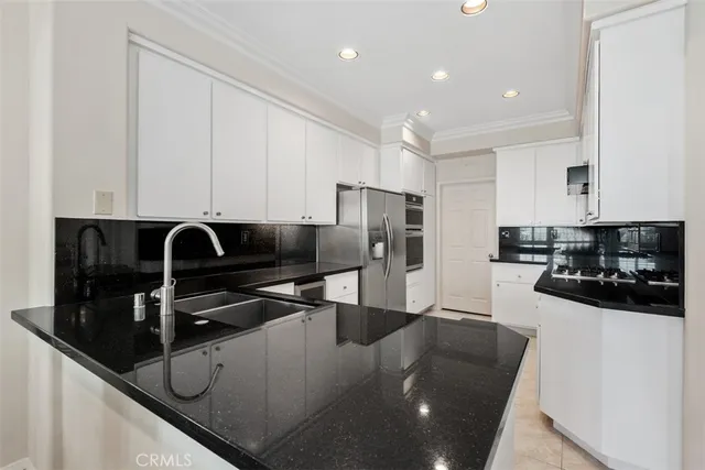 a kitchen with stainless steel appliances granite countertop a sink and cabinets