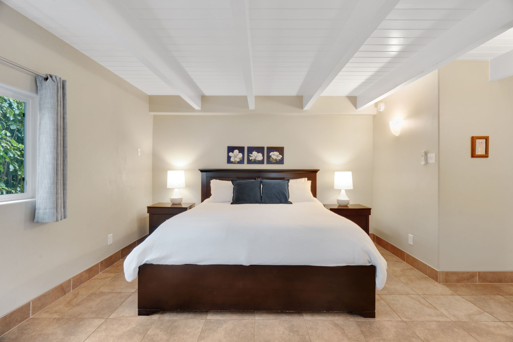 4460 Aku Road Hanalei, HI 96714 - Photo 19 of 30 a bedroom with a bed and window