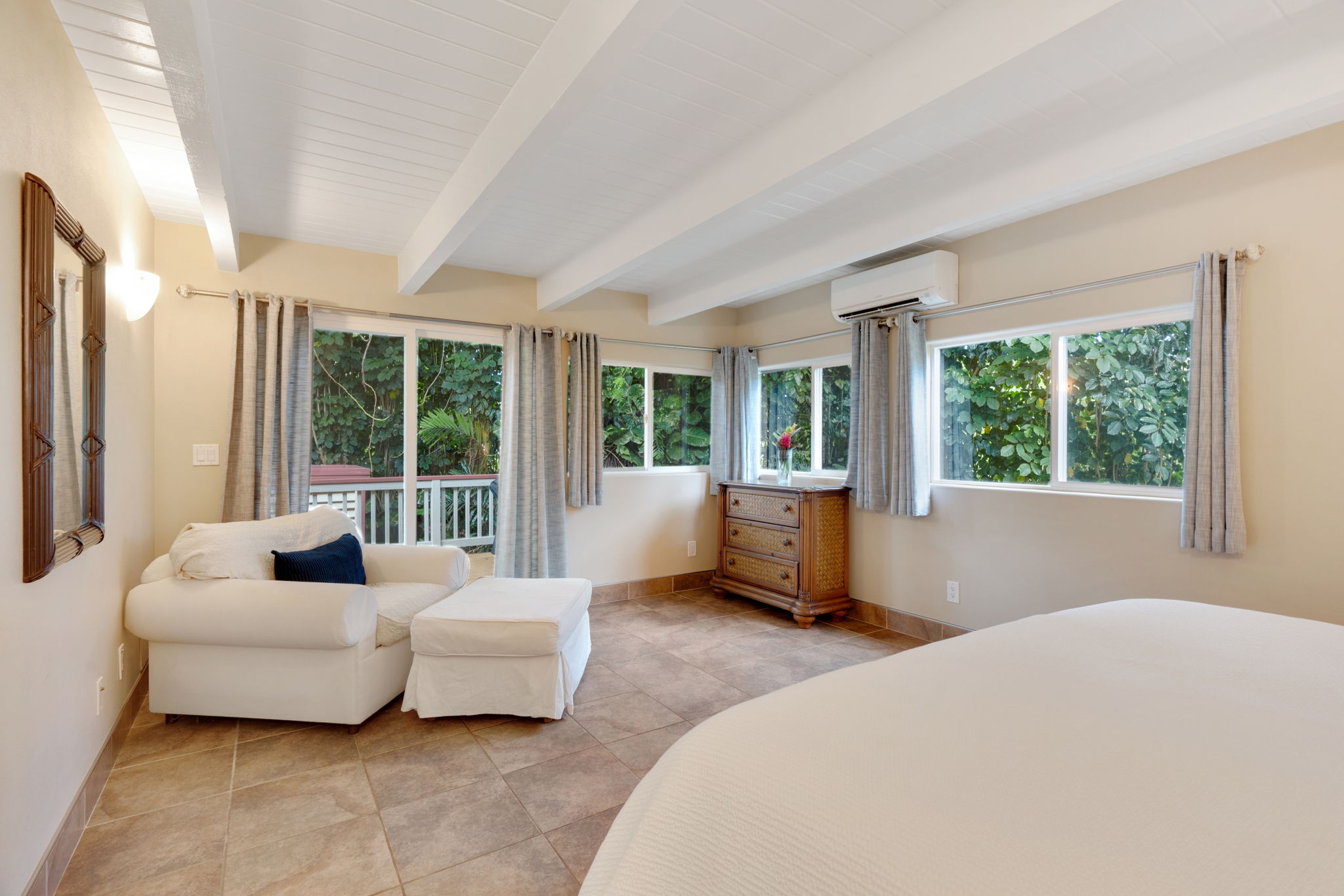 4460 Aku Road Hanalei, HI 96714 - Photo 20 of 30 a bedroom with furniture and large windows