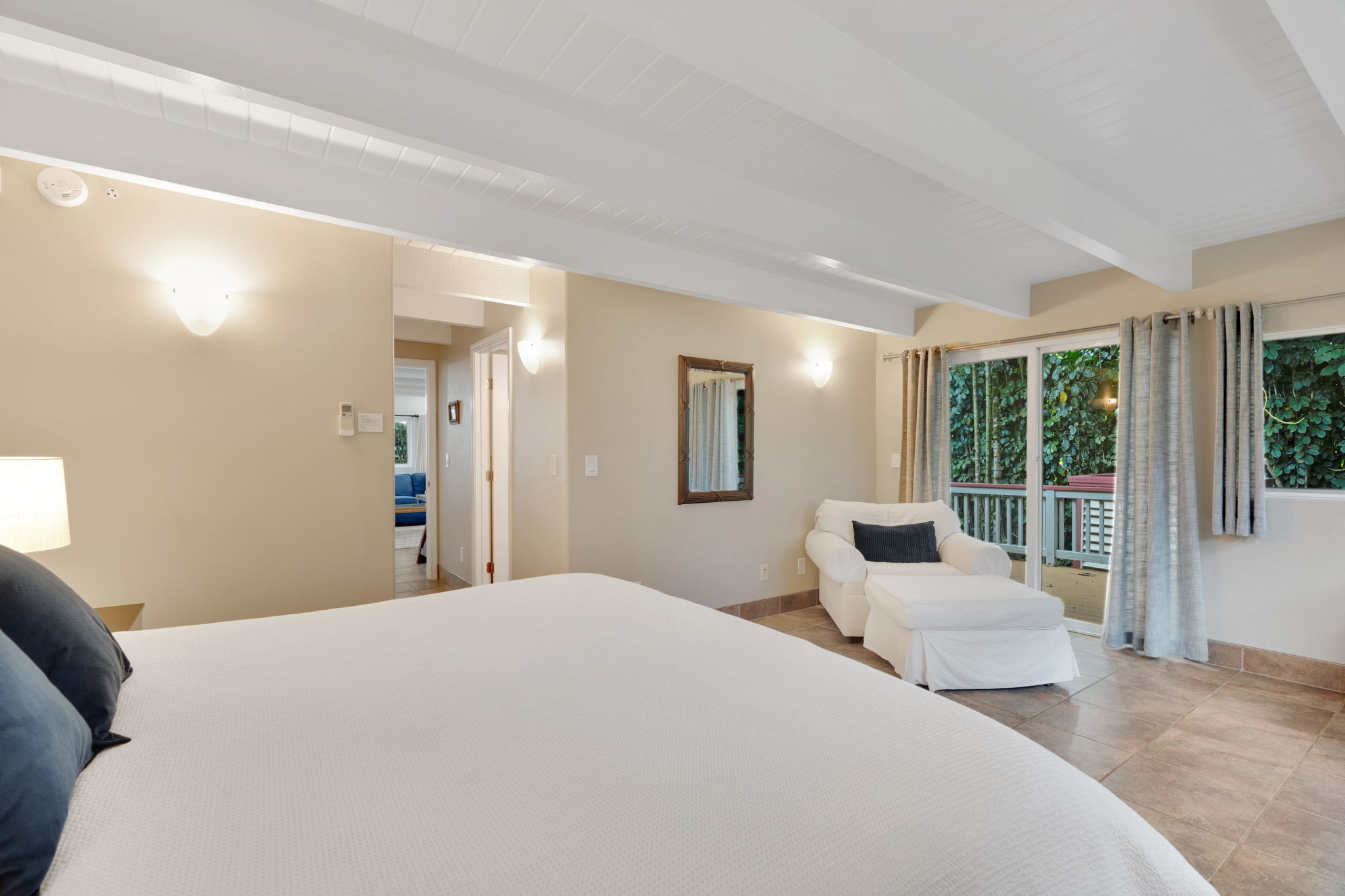 4460 Aku Road Hanalei, HI 96714 - Photo 21 of 30 a bedroom with a large bed and a couch