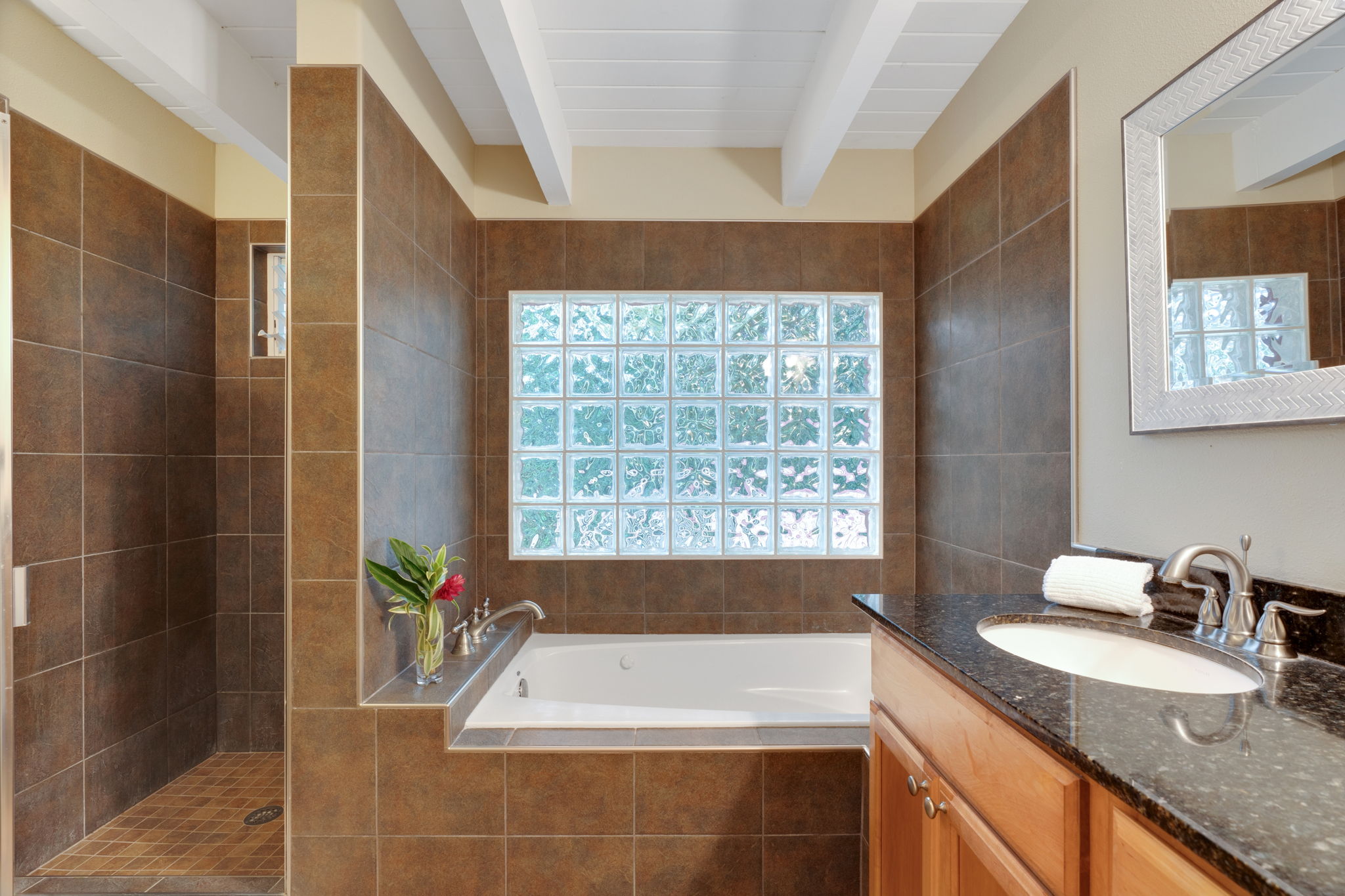 4460 Aku Road Hanalei, HI 96714 - Photo 24 of 30 a bathroom with a granite countertop sink a bathtub and next to a window