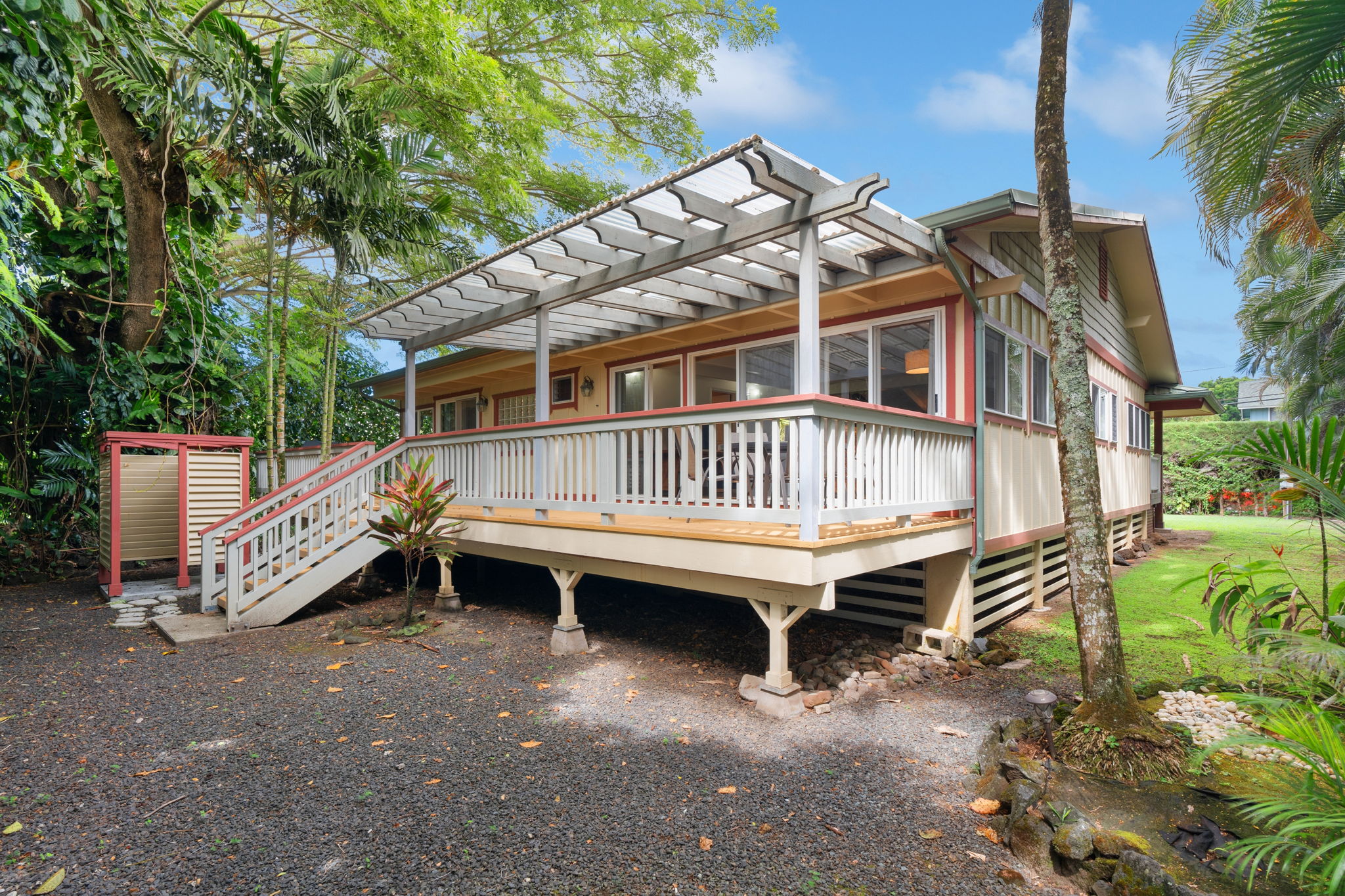 4460 Aku Road Hanalei, HI 96714 - Photo 27 of 30 a view of a house with a wooden deck and a yard