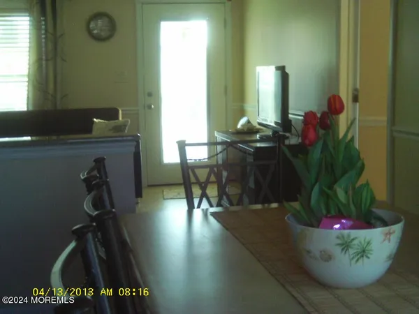 a view of a room with wooden floor and furniture
