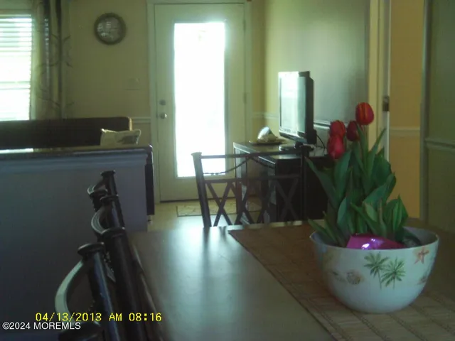 a view of a room with wooden floor and furniture