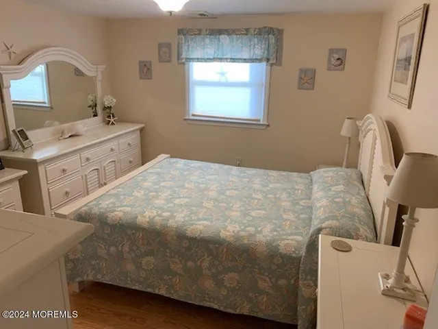 a bedroom with a bed and a dresser