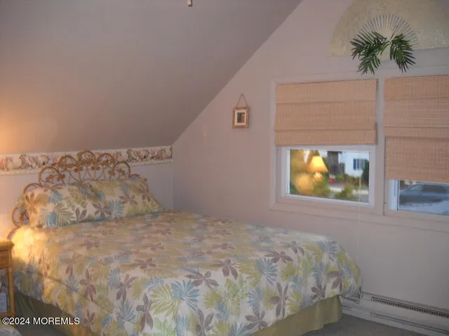 a bedroom with a bed and a potted plant