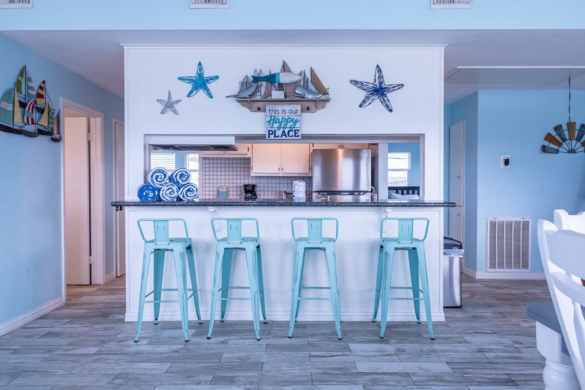 21614 Termini-San Luis Pass Road Galveston, TX 77554 - Photo 17 of 31 a dining room with granite countertop wooden floor