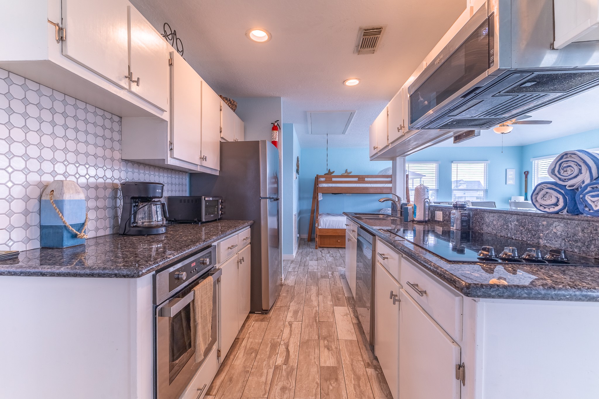 21614 Termini-San Luis Pass Road Galveston, TX 77554 - Photo 18 of 31 a kitchen with stainless steel appliances granite countertop a stove a sink and a refrigerator