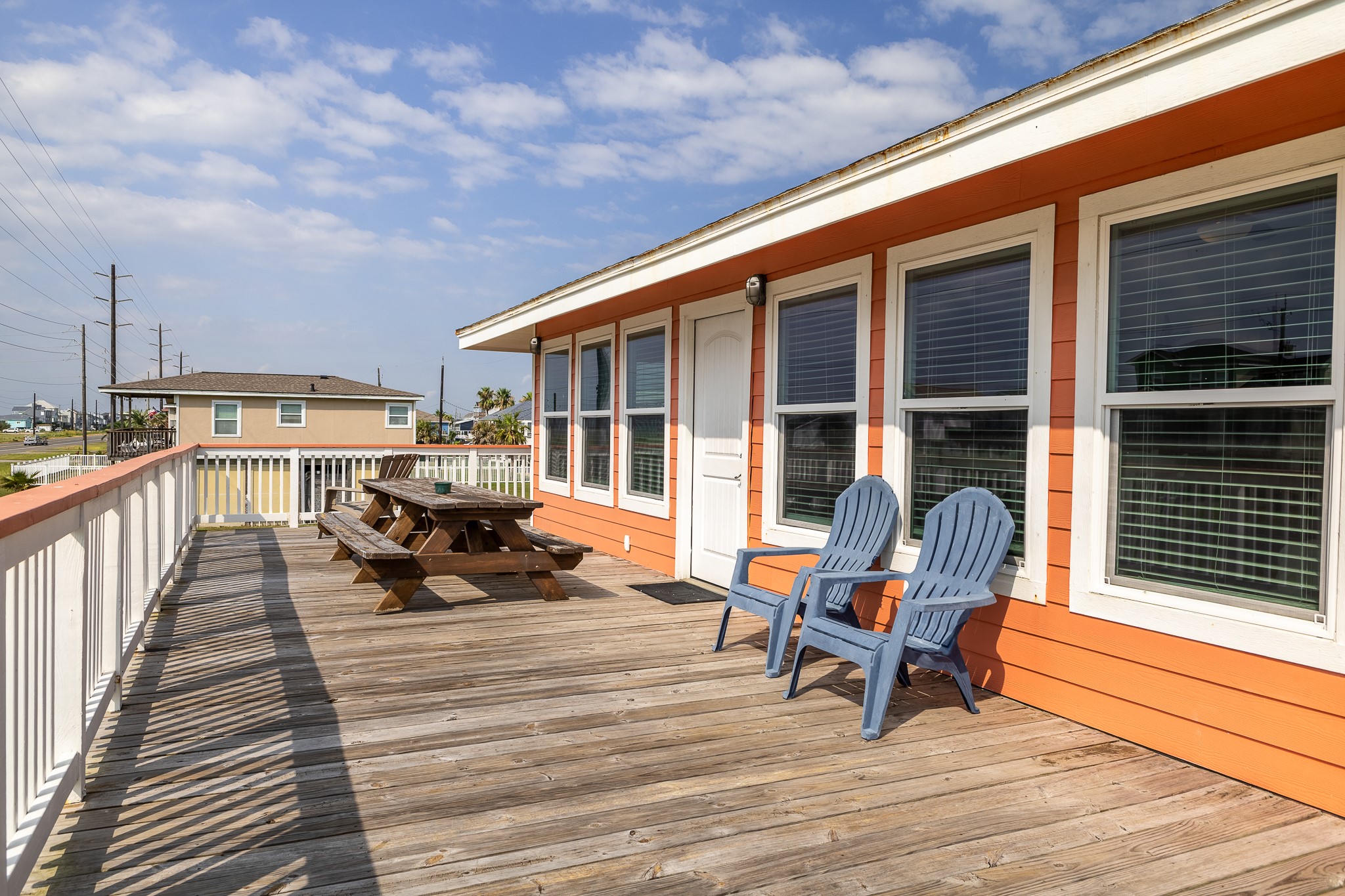 21614 Termini-San Luis Pass Road Galveston, TX 77554 - Photo 25 of 31 a view of a deck with table and chairs with wooden floor and fence