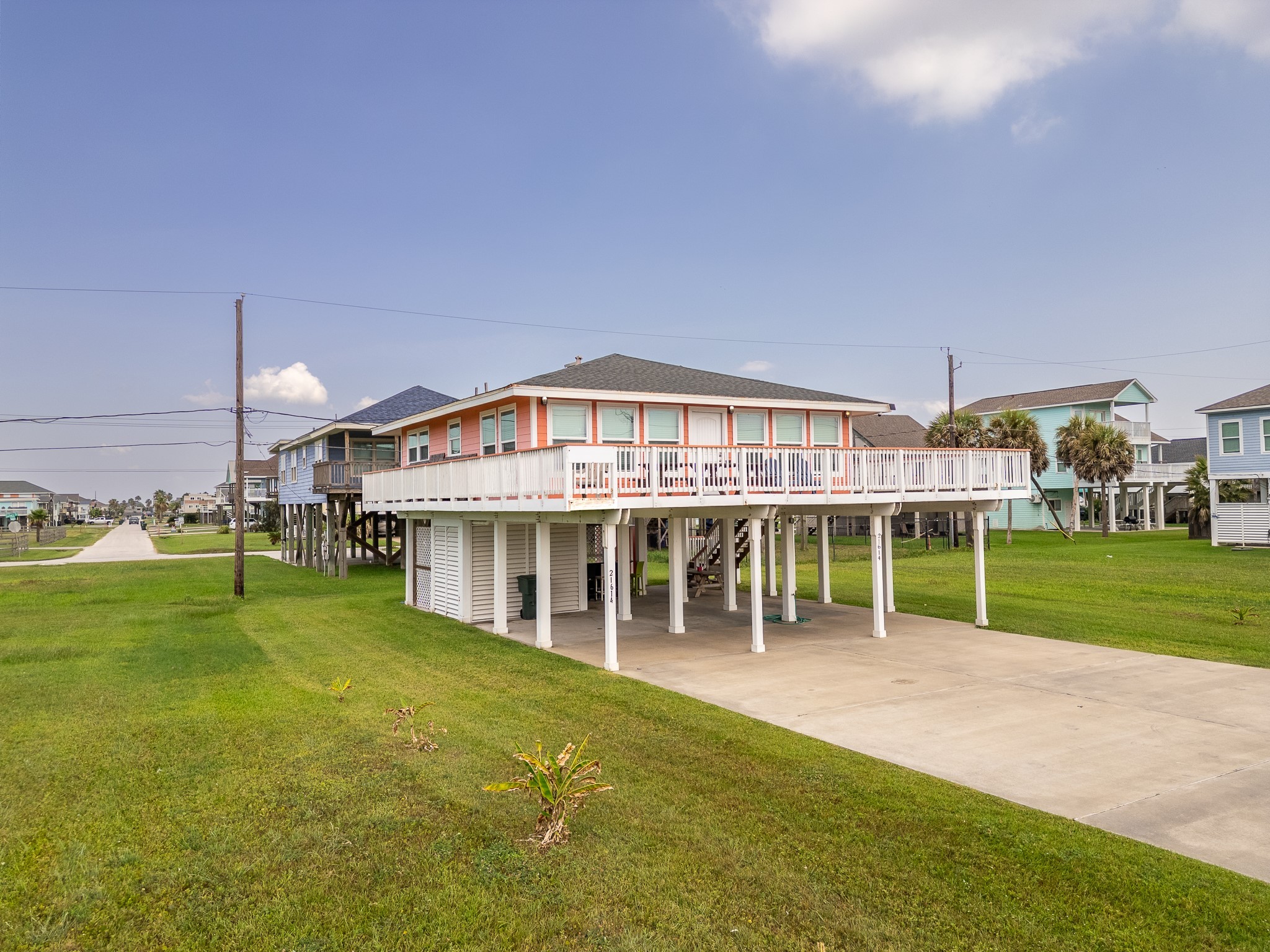 21614 Termini-San Luis Pass Road Galveston, TX 77554 - Photo 3 of 31 a view of a house next to a big yard with large trees
