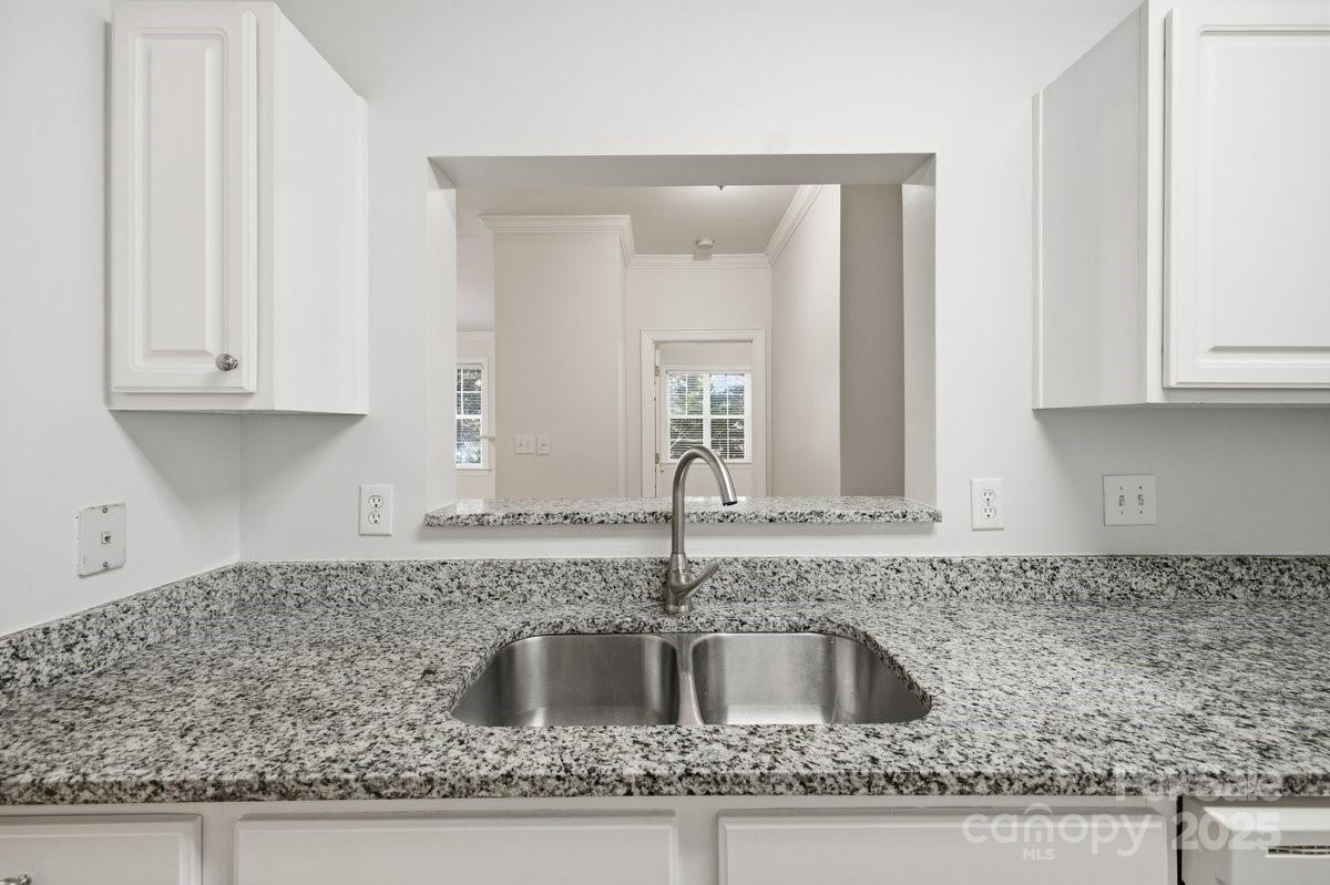 5617 Fairview Road, Unit 6 Charlotte, NC 28209 - Photo 12 of 38 a kitchen with granite countertop a sink and cabinets