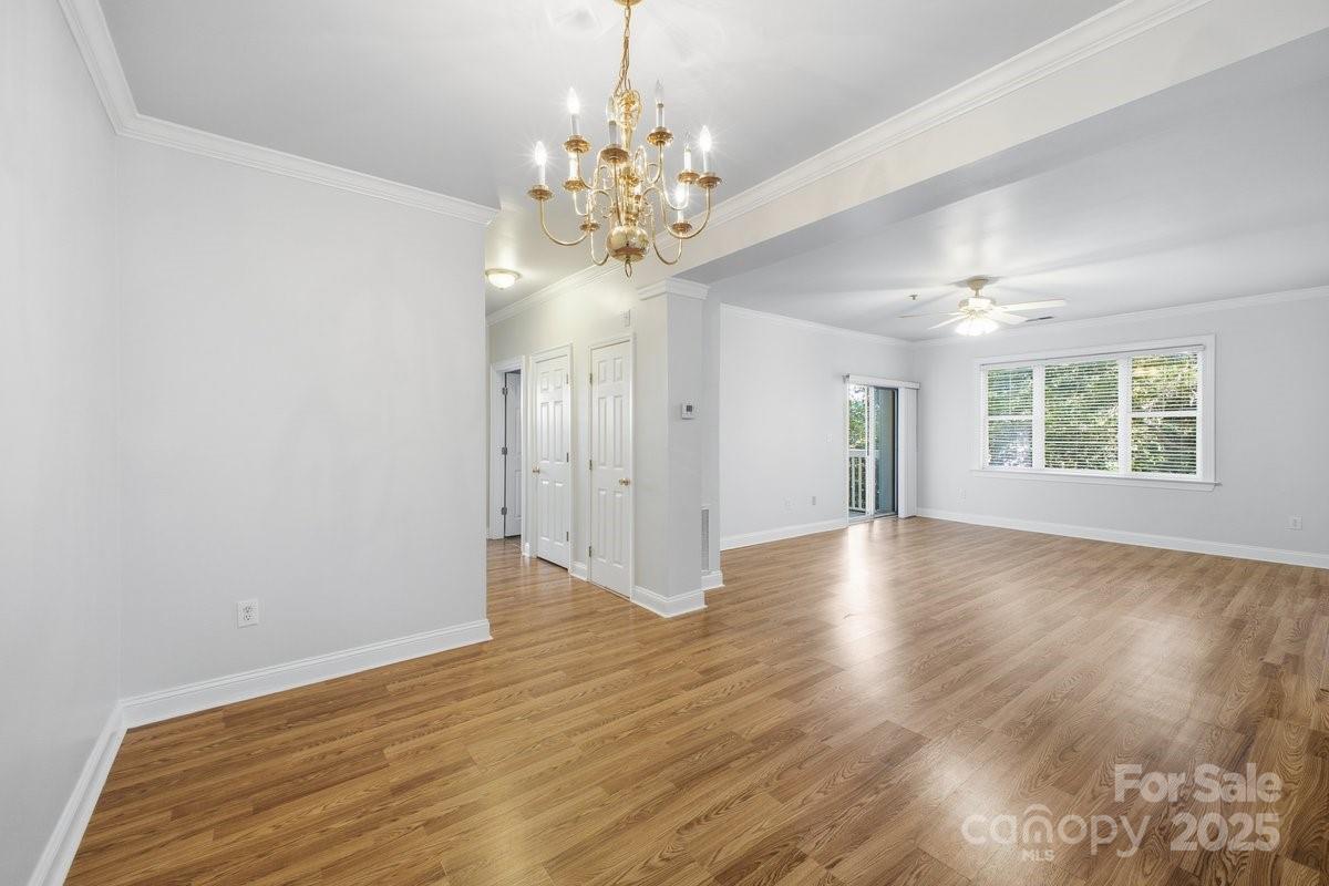 5617 Fairview Road, Unit 6 Charlotte, NC 28209 - Photo 14 of 38 a view of an empty room with wooden floor and a window