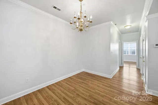 a view of a room with wooden floor and window
