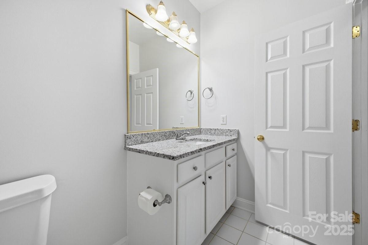 5617 Fairview Road, Unit 6 Charlotte, NC 28209 - Photo 23 of 38 a bathroom with a granite countertop sink and a mirror