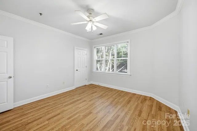 a view of empty room with wooden floor