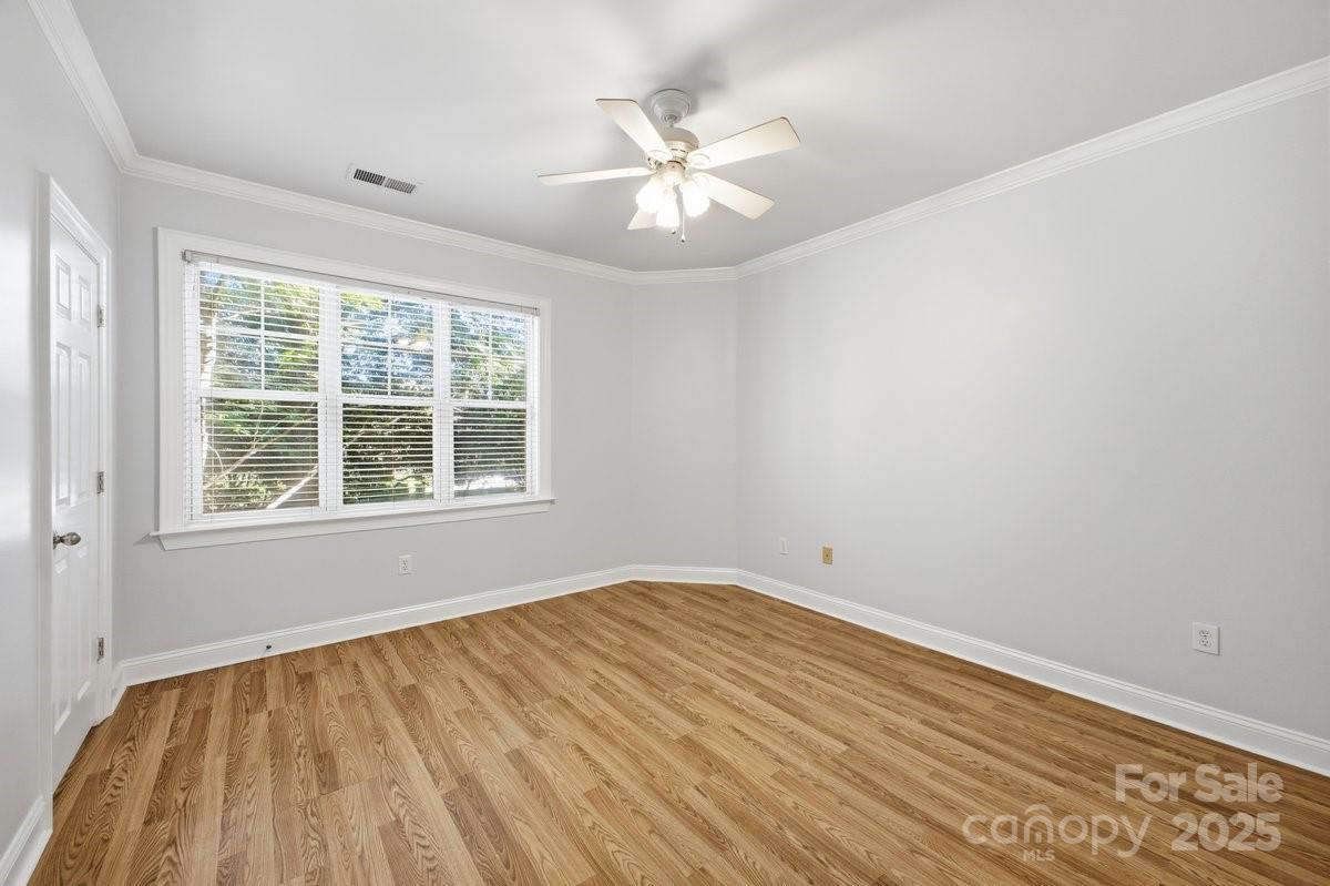 5617 Fairview Road, Unit 6 Charlotte, NC 28209 - Photo 29 of 38 wooden floor in an empty room with a window