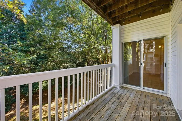 a view of a balcony with wooden floor