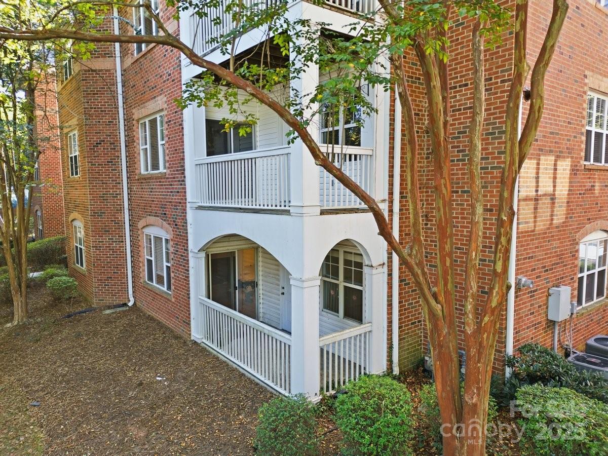 5617 Fairview Road, Unit 6 Charlotte, NC 28209 - Photo 35 of 38 a view of a white house next to a yard