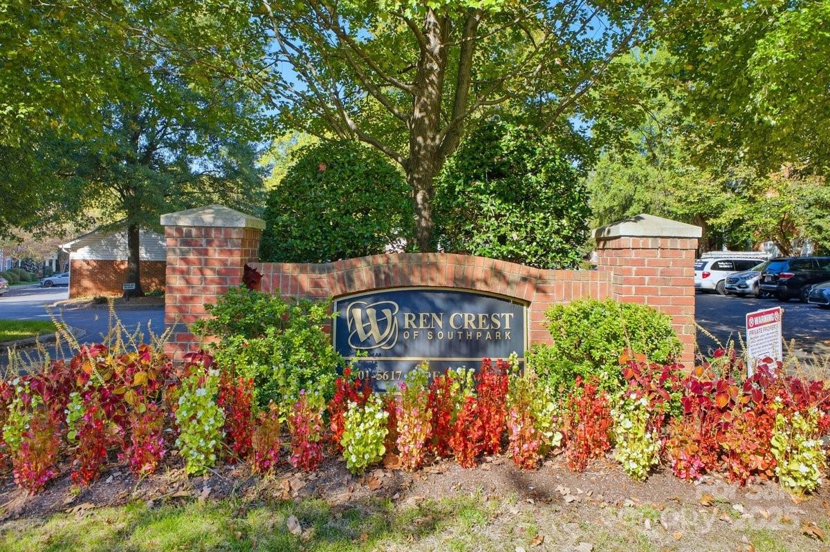 5617 Fairview Road, Unit 6 Charlotte, NC 28209 - Photo 37 of 38 a sign that is sitting in front of flowers