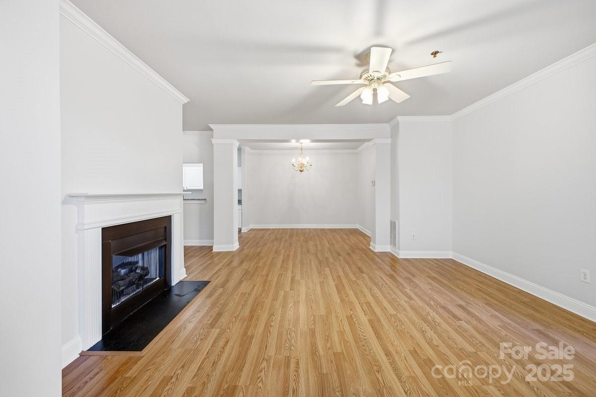 5617 Fairview Road, Unit 6 Charlotte, NC 28209 - Photo 6 of 38 a view of a livingroom with wooden floor and a fireplace