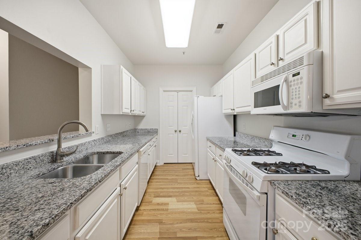 5617 Fairview Road, Unit 6 Charlotte, NC 28209 - Photo 10 of 38 a kitchen with stainless steel appliances granite countertop a sink stove and cabinets