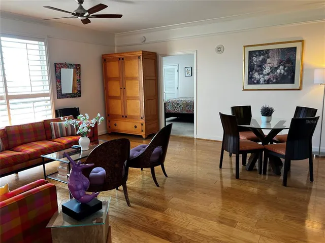 a living room with furniture a window and a flat screen tv