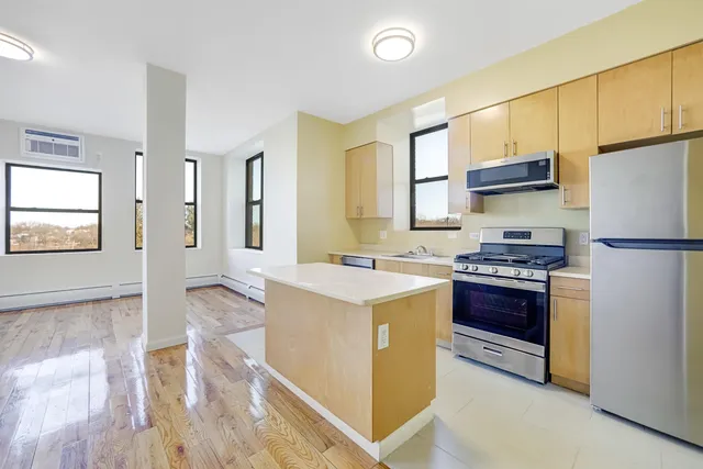 a kitchen with stainless steel appliances granite countertop a stove a refrigerator and a refrigerator