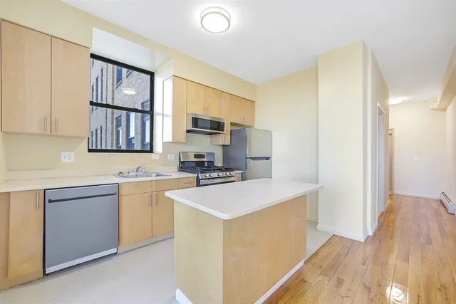 a kitchen with stainless steel appliances granite countertop a stove a sink dishwasher and a refrigerator