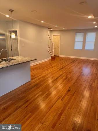a view of a room with wooden floor