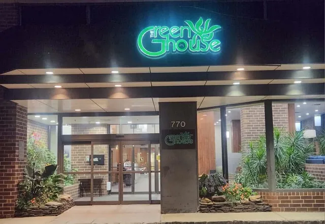 a view of a entryway door with potted plants