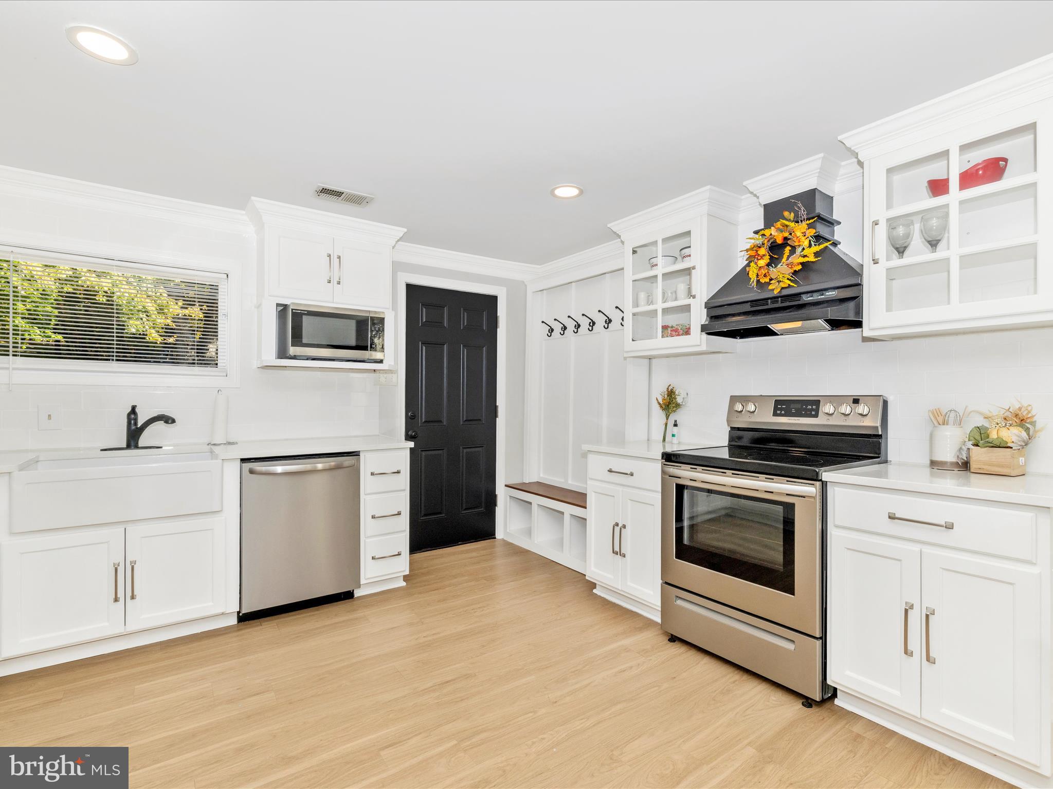 1410 Woodenbridge Lane Mount Airy, MD 21771 - Photo 12 of 50 a kitchen with stainless steel appliances a stove a sink and a refrigerator