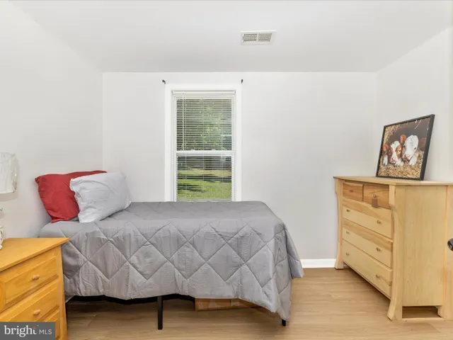 a bedroom with a bed and dresser