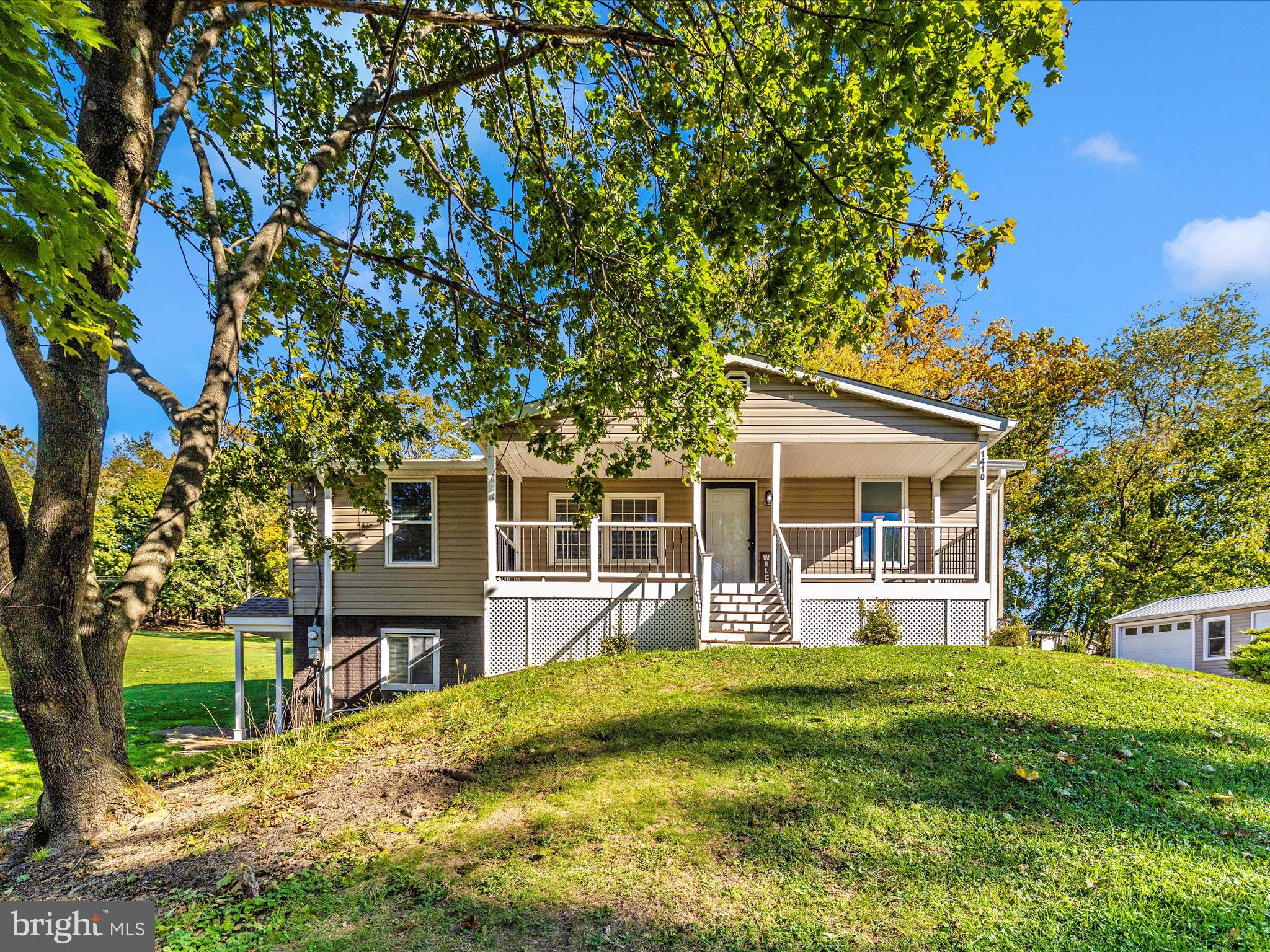 1410 Woodenbridge Lane Mount Airy, MD 21771 - Photo 2 of 50 a view of a house with a yard