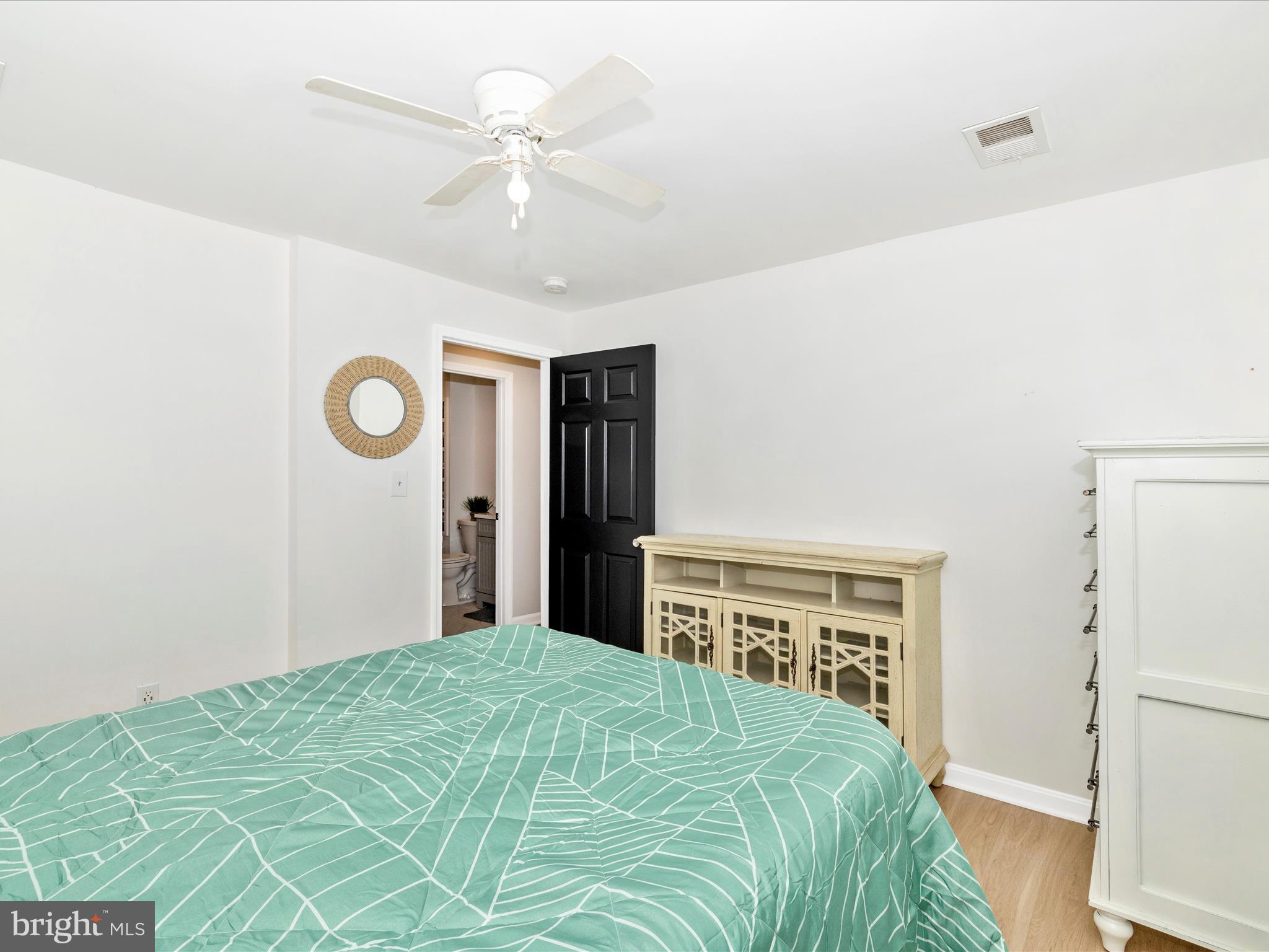 1410 Woodenbridge Lane Mount Airy, MD 21771 - Photo 27 of 50 a bedroom with a large bed and a chandelier
