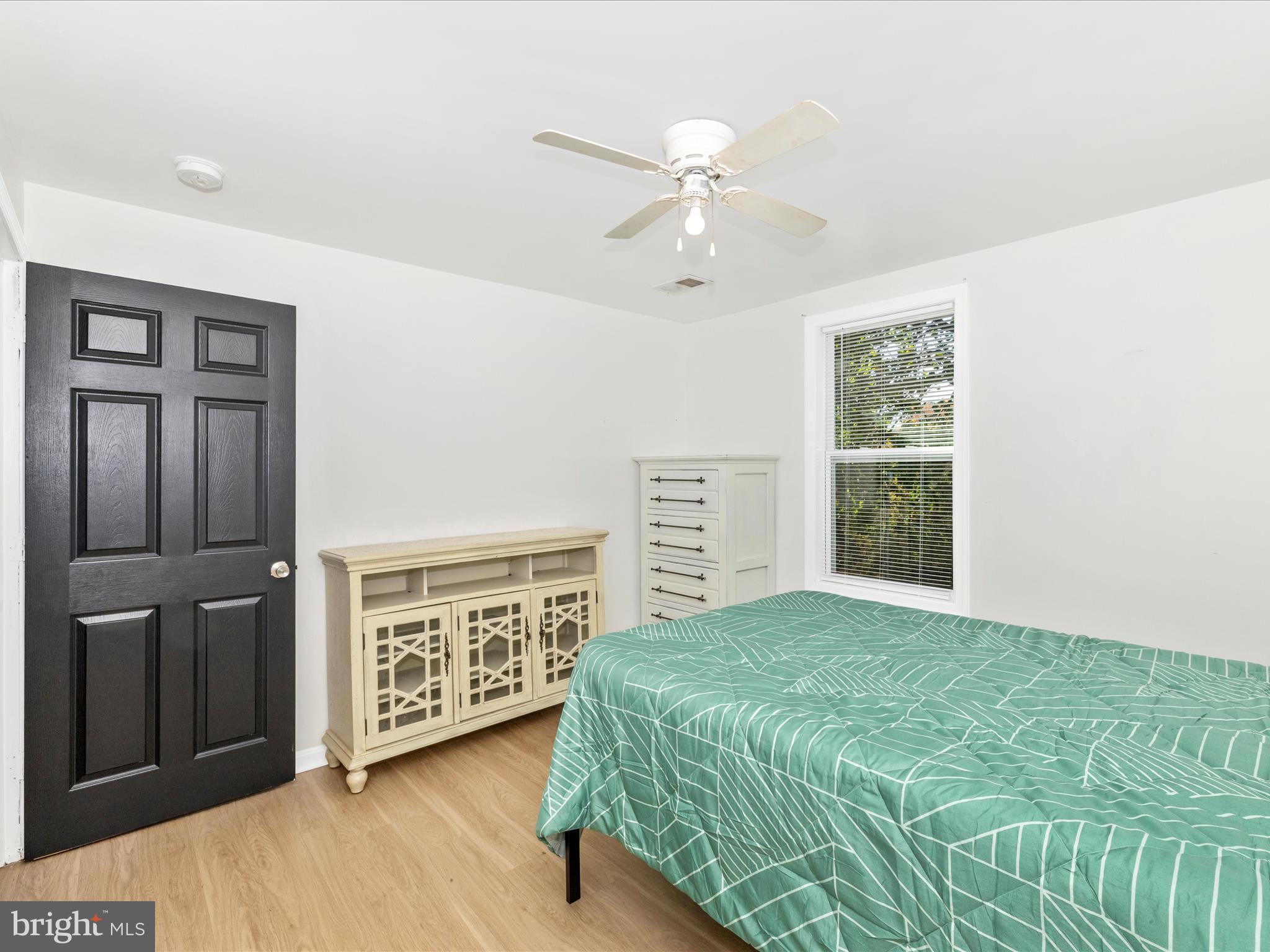 1410 Woodenbridge Lane Mount Airy, MD 21771 - Photo 28 of 50 a spacious bedroom with a large bed and a chandelier
