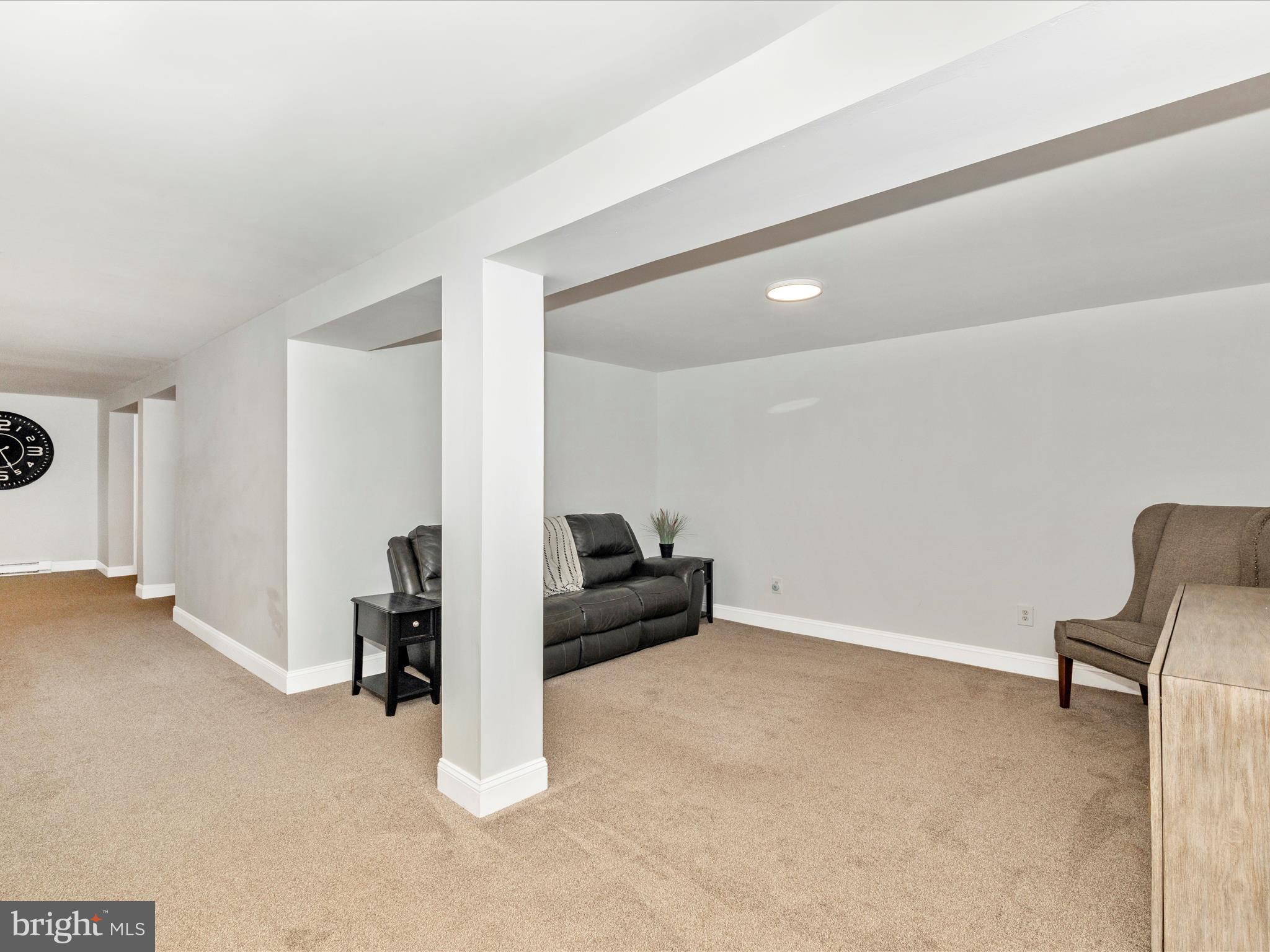1410 Woodenbridge Lane Mount Airy, MD 21771 - Photo 30 of 50 a living room with furniture and a couch