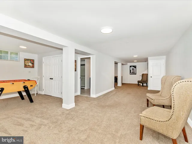 a living room with furniture and a lamp