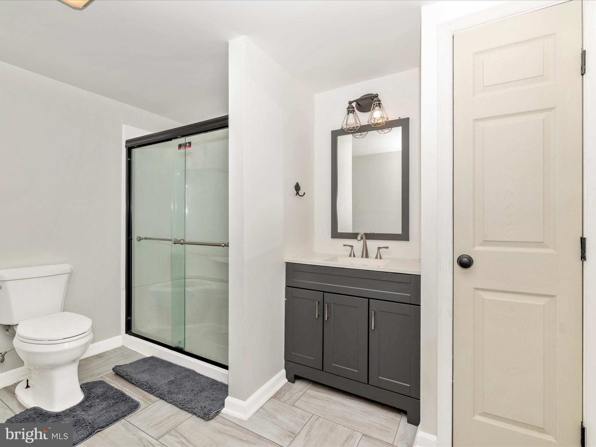 1410 Woodenbridge Lane Mount Airy, MD 21771 - Photo 38 of 50 a bathroom with a toilet sink and mirror