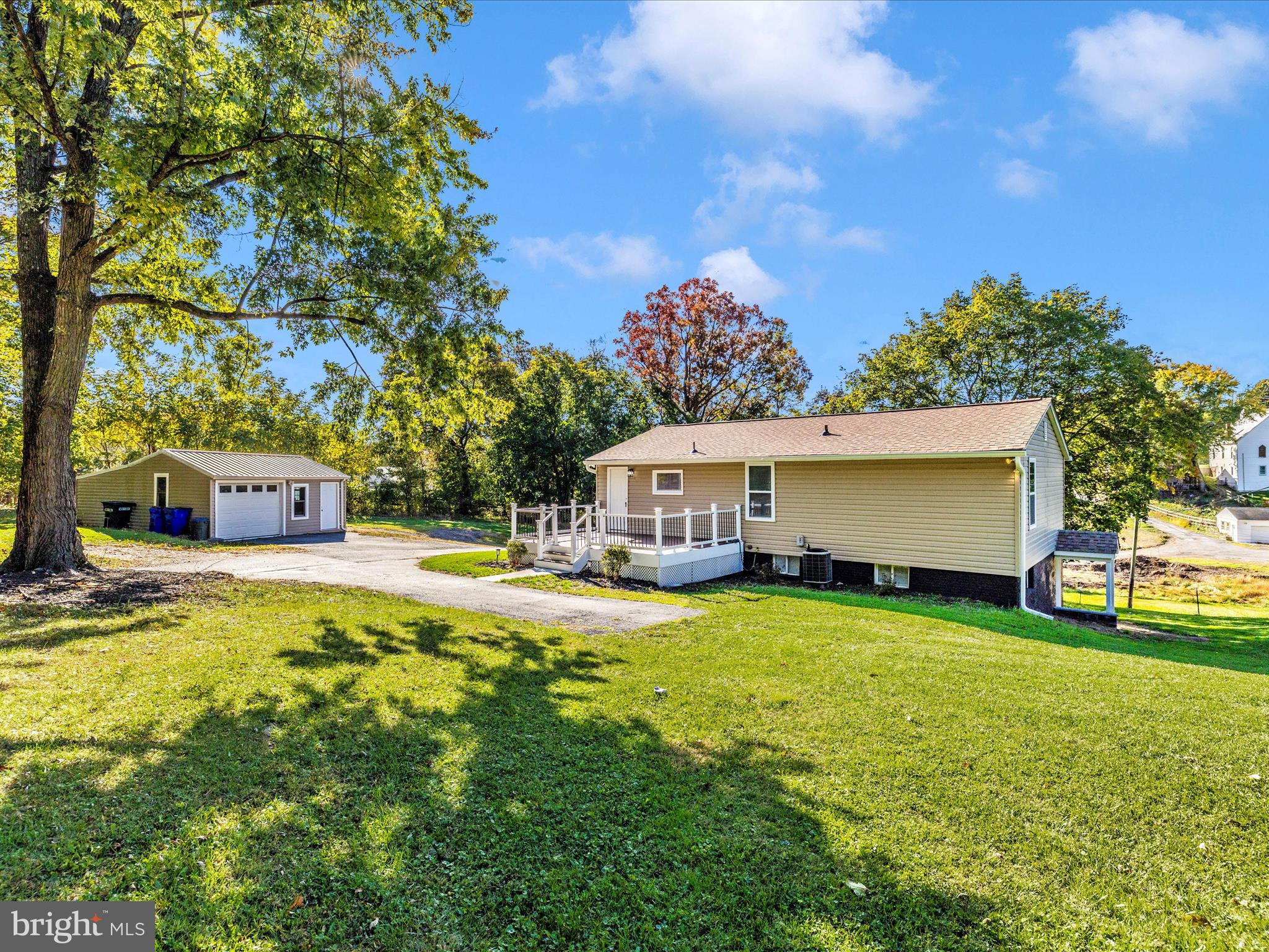 1410 Woodenbridge Lane Mount Airy, MD 21771 - Photo 46 of 50 a front view of a house with a garden and trees
