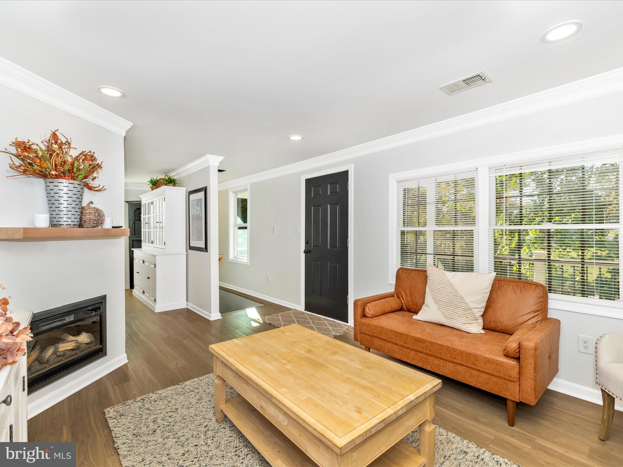 1410 Woodenbridge Lane Mount Airy, MD 21771 - Photo 7 of 50 a living room with furniture a rug and a fireplace